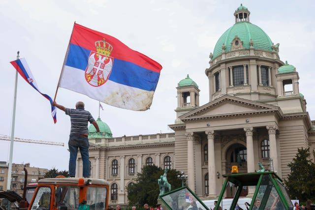 A protester waves a Serbian flag