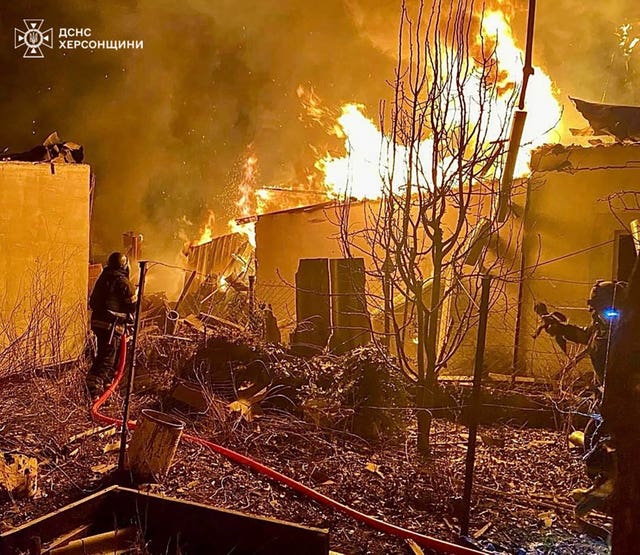 Firefighters dealing with a fire following a Russian guided air bombs attack in Kherson