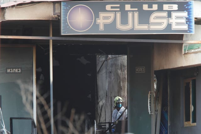 A firefighter inspects a nightclub after a blaze in the town of Kocani, North Macedonia