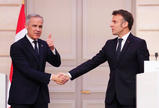 Canada Prime Minister Mark Carney gives a thumbs up as he shakes hands with President of France Emmanuel Macron on Monday 