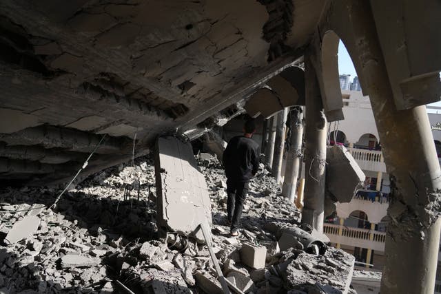 People inspect the damage at Al-Tabi’in School in central Gaza Strip following an Israeli airstrike