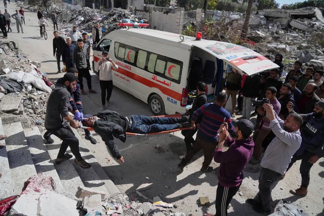 Palestinians evacuate an injured man after his house was hit by an Israeli bombardment in Gaza City on Wednesday