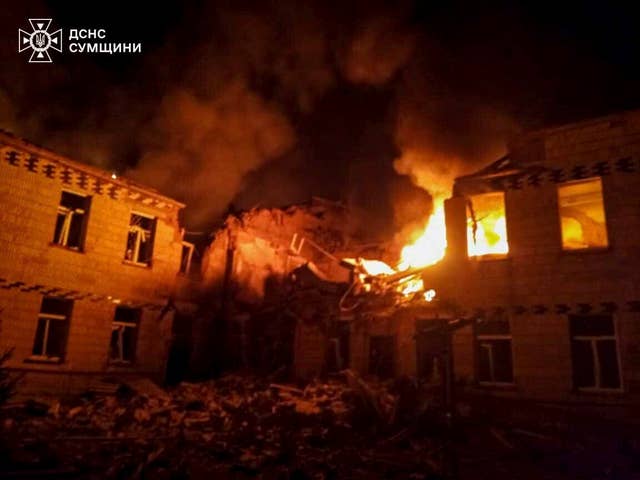 Flames smoke engulf a building after a Russian attack in Krasnopillia