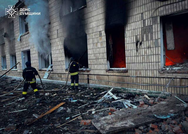 Firefighters work at the site of a Russian attack in Krasnopillia, Sumy region, Ukraine 