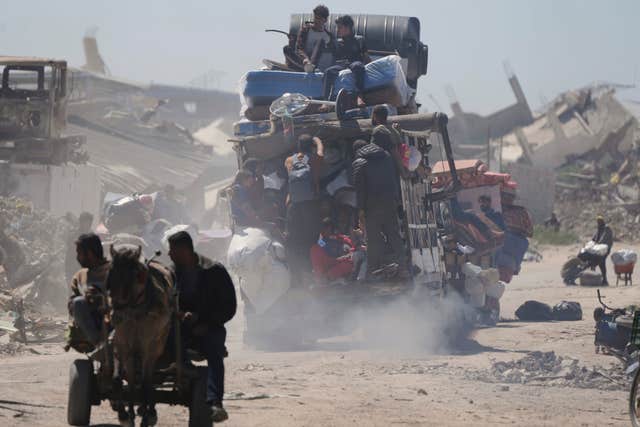 Displaced Palestinians carry their belongings as they travel from Beit Hanoun to Jabaliya after Israel’s renewed offensive in the Gaza Strip 