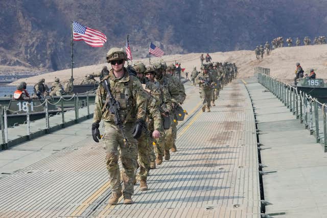 US Army soldiers cross a floating bridge on the Imjin River during a joint river-crossing exercise between South Korea and the United States as a part of the Freedom Shield military exercise in Yeoncheon, South Korea 