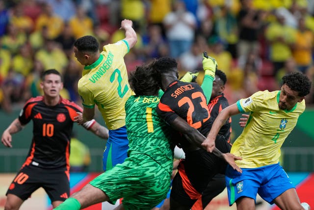 Brazil’s goalkeeper Alisson Becker clashes heads with Colombia’s Davinson Sanchez 