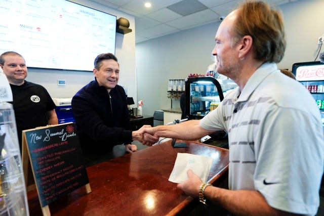 Conservative Leader Pierre Poilievre greets a supporter as he campaigns at a a cafe in the Orleans community of Ottawa