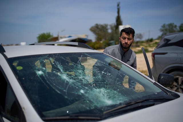 Basel Adra, co-director of No Other Land, looks at a damaged car