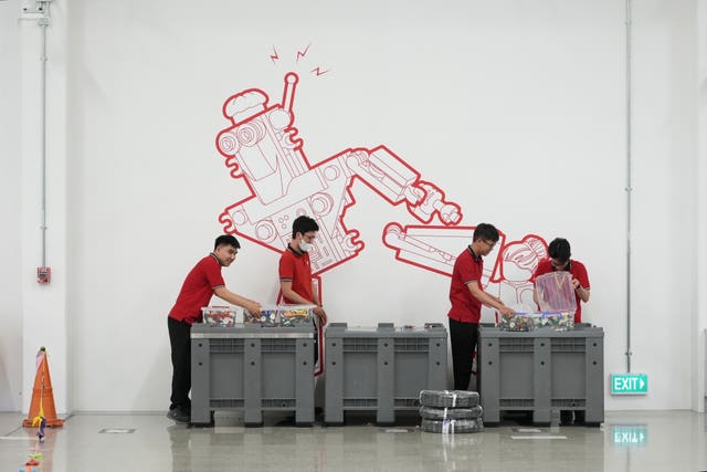 Workers sort out Lego bricks at Lego factory