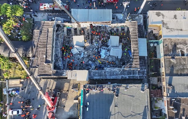 Rescue workers search for survivors at the Jet Set nightclub after its roof collapsed viewed from above