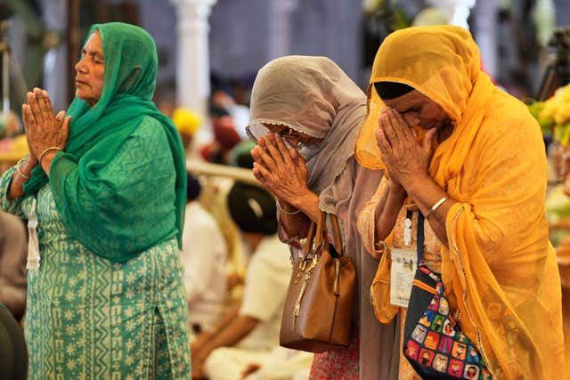 Sikh pilgrims perform rituals at a ceremony to mark the Vaisakhi festival 