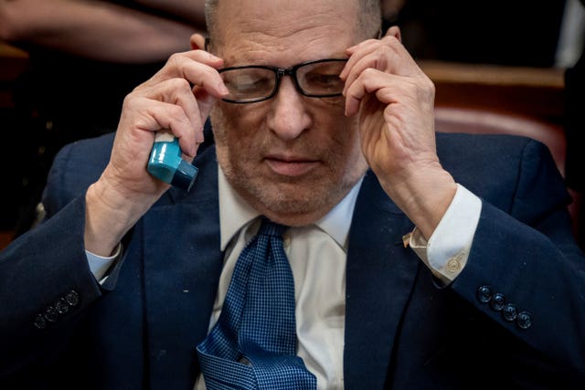Harvey Weinstein in court holding an inhaler