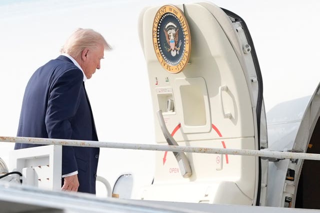 President Donald Trump boards Air Force One at Palm Beach International Airport on Sunday
