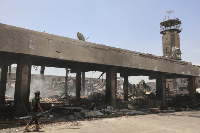 A Yemeni officer inspects the damage after Israeli airstrikes on Sanaa International Airport 