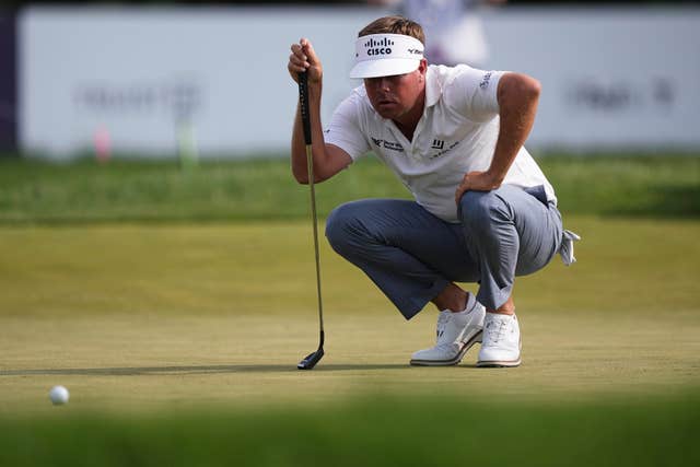 Keith Mitchell lines his putt on the ninth hole