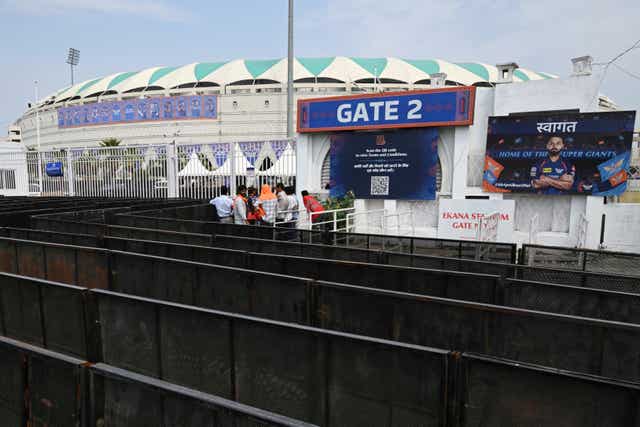 Fans wait outside a closed entrance of Atal Bihari Vajpayee Ekana Cricket Stadium after organizers suspended the Indian Premier League for one week