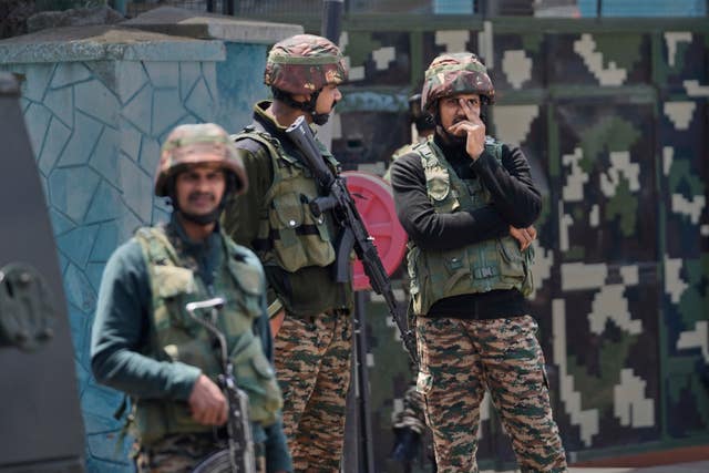 Indian army soldiers stand guard after loud explosions were heard in Srinagar, Indian controlled Kashmir