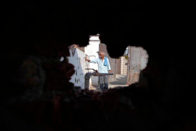 A hole blasted in the wall of a house