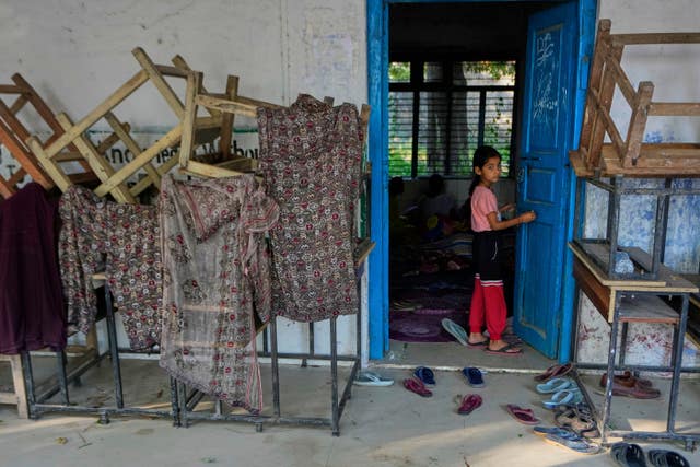 A girl evacuated from her village along the India Pakistan border takes refuge in a makeshift centre in a school 