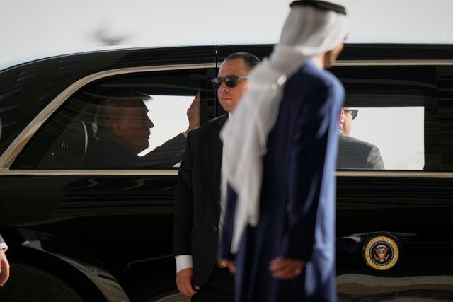 US president Donald Trump sits in a car