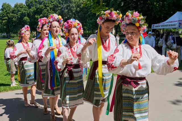 Women in traditional dresses prepare to dance in a park during a family meeting with Ukrainians and their Eurovision competition band Ziferblat as part of the 69th Eurovision Song Contest week in Basel, Switzerland