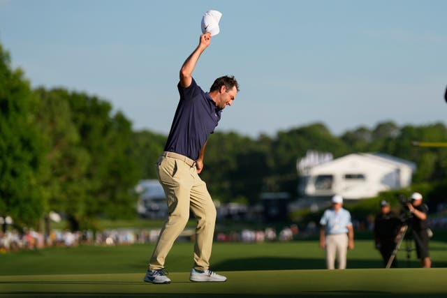 Scottie Scheffler prepares to slam his cap on the green