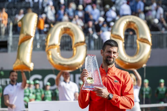 Winner Novak Djokovic of Serbia poses with the trophy 