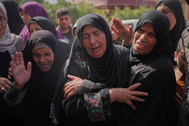 Palestinians mourn during the funeral of Reem Al-Akhras, who was killed while heading to an aid distribution hub, in Khan Younis, Gaza Strip,