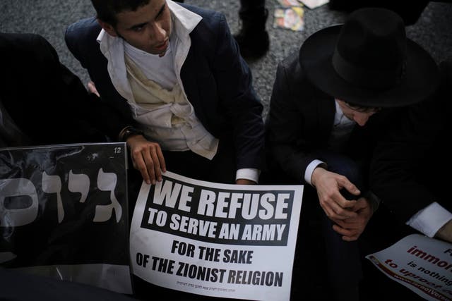 Ultra-Orthodox Jewish men block a highway during a protest against army recruitment in Bnei Brak, Israel
