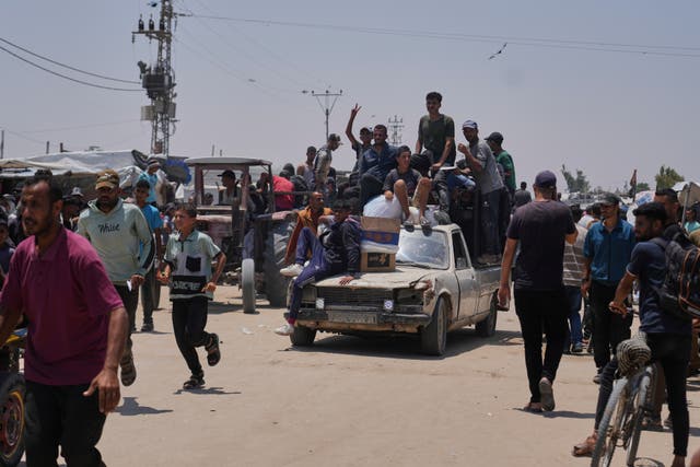 Palestinians carry food and humanitarian aid packages