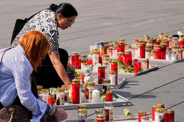 People light candles on the main square in Graz, Austria