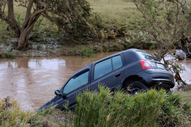 An abandoned vehicle in a flooded area in Mthatha