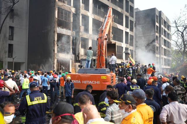 Search and rescue teams at the scene of a plane crash in India