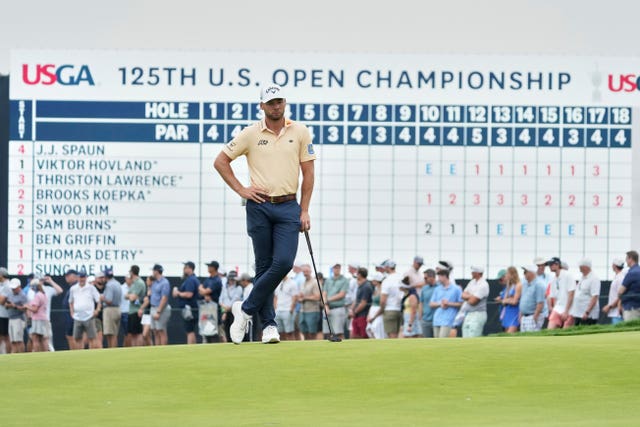 Sam Burns waits on the green 