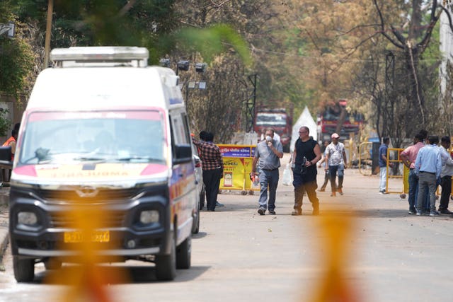 Investigators come out after visiting the Air India plane crash site in Ahmedabad, India 