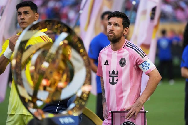 Inter Miami’s Lionel Messi (right) and goalkeeper Oscar Ustari stand next to the trophy prior to the Club World Cup group A match against Al Ahly