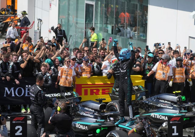 Russell, centre right, celebrates his victory 