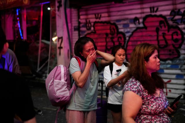 People evacuating after a missile launched from Iran struck Tel Aviv