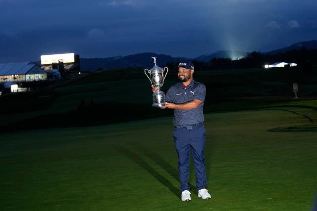 JJ Spaun holds the US Open trophy as darkness descends on Oakmont