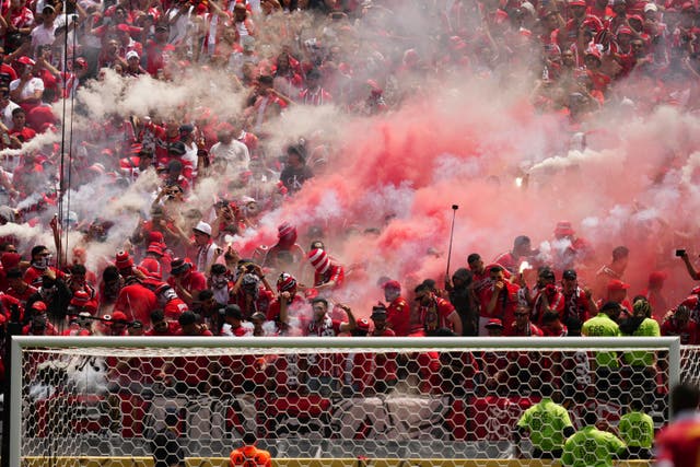 Wydad Casablanca’s supporters light torches during the Club World Cup match with Manchester City
