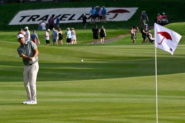 Scottie Scheffler hits his second shot on the 15th hole 
