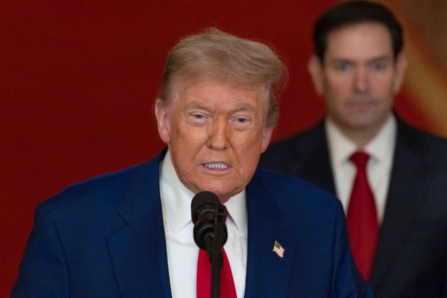 Donald Trump speaks into a mic