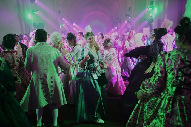 Costumed guests dance at the Great Masked Ball