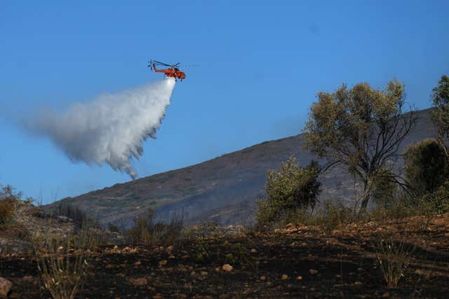 A firefighting aircraft drops water in Greece