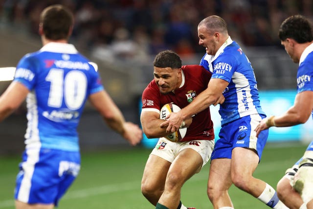 Sione Tuipulotu, centre, is tackled by Western Force's Dylan Pietsch, right