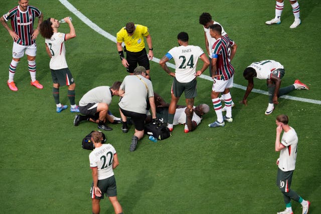 Chelsea’s Moises Caicedo lies on the pitch receiving medical attention during the game against Fluminense
