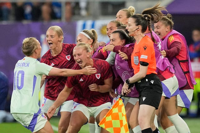 Wales’ Jess Fishlock, left, celebrates with team-mates after scoring against France