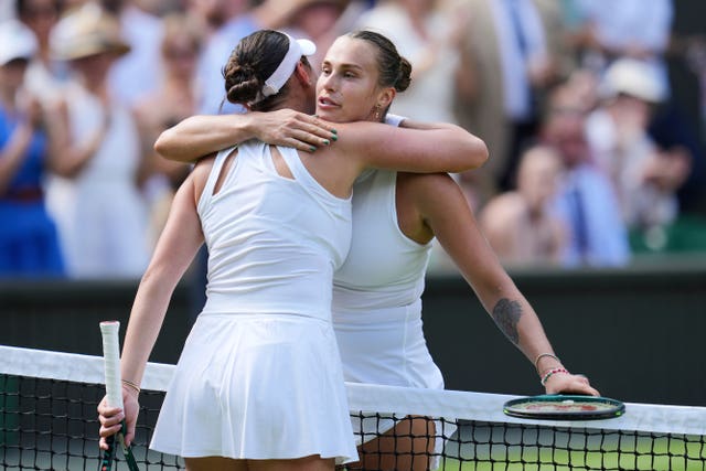 Aryna Sabalenka, right, hugs Amanda Anisimova after their Wimbledon semi-final 