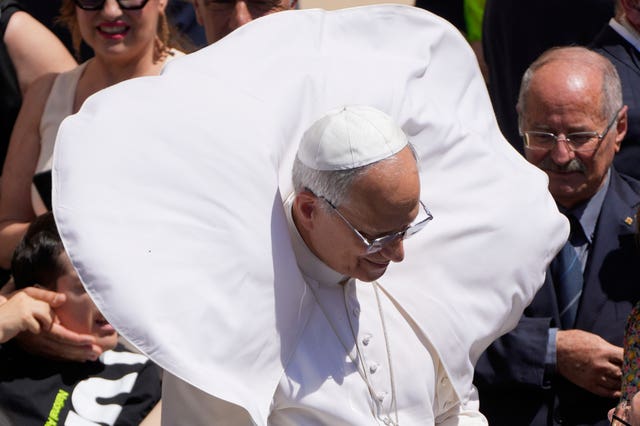 Pope Leo's mantle is blown up by the wind